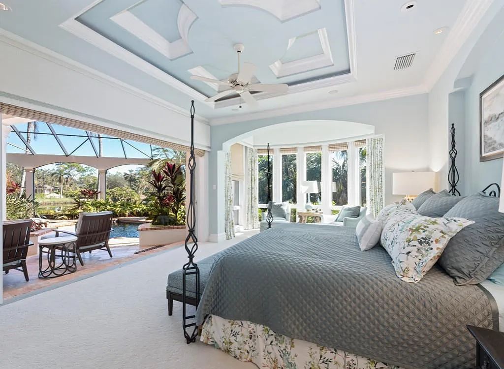 26079 Fawnwood Court, Bonita Springs, Florida, is a beautiful lakefront home built on a prominent corner lot in desirable Spring Ridge. With warm and inviting décor and a separate waterfall flowing into a tropical lagoon pool, it is a timeless design.