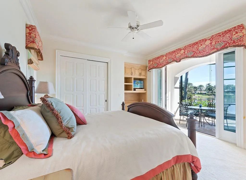 26079 Fawnwood Court, Bonita Springs, Florida, is a beautiful lakefront home built on a prominent corner lot in desirable Spring Ridge. With warm and inviting décor and a separate waterfall flowing into a tropical lagoon pool, it is a timeless design.