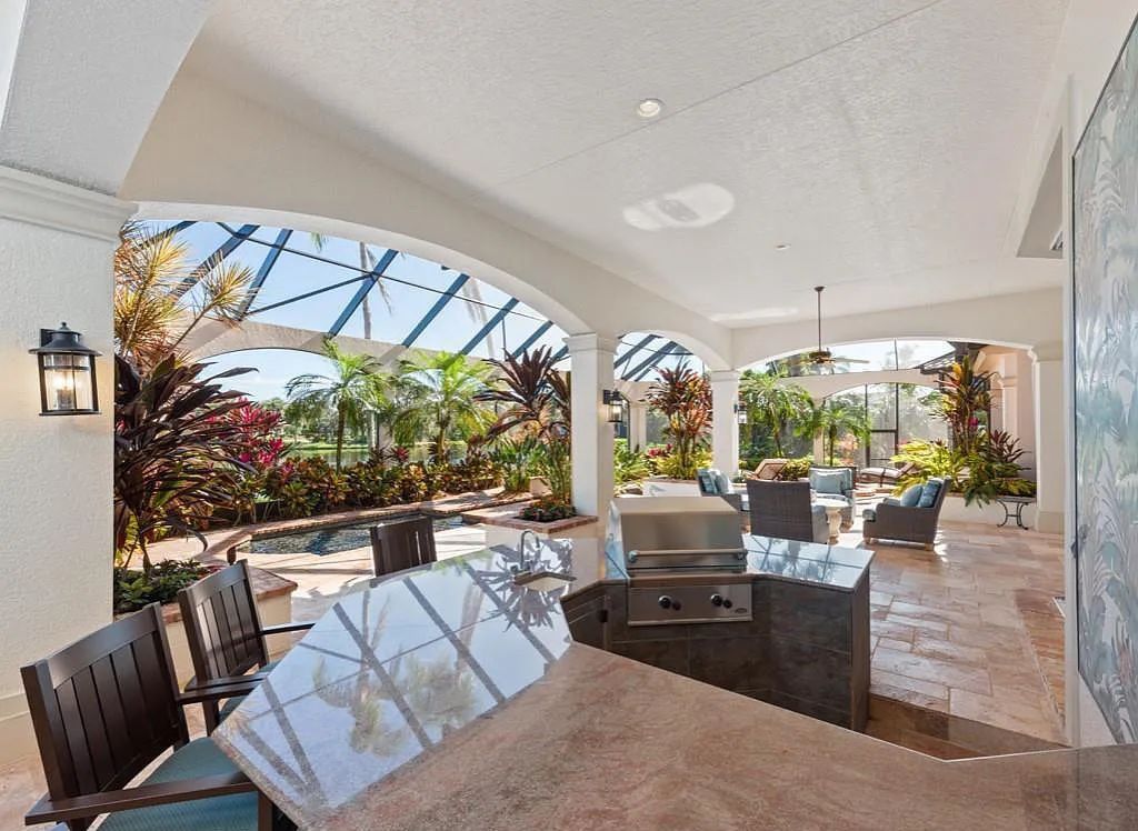 26079 Fawnwood Court, Bonita Springs, Florida, is a beautiful lakefront home built on a prominent corner lot in desirable Spring Ridge. With warm and inviting décor and a separate waterfall flowing into a tropical lagoon pool, it is a timeless design.