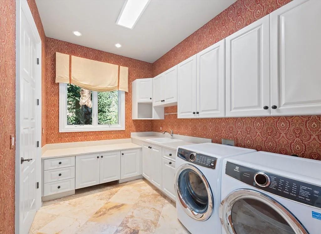 26079 Fawnwood Court, Bonita Springs, Florida, is a beautiful lakefront home built on a prominent corner lot in desirable Spring Ridge. With warm and inviting décor and a separate waterfall flowing into a tropical lagoon pool, it is a timeless design.