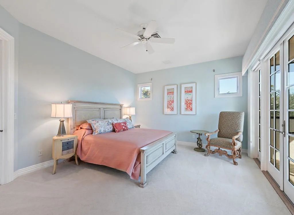 26079 Fawnwood Court, Bonita Springs, Florida, is a beautiful lakefront home built on a prominent corner lot in desirable Spring Ridge. With warm and inviting décor and a separate waterfall flowing into a tropical lagoon pool, it is a timeless design.