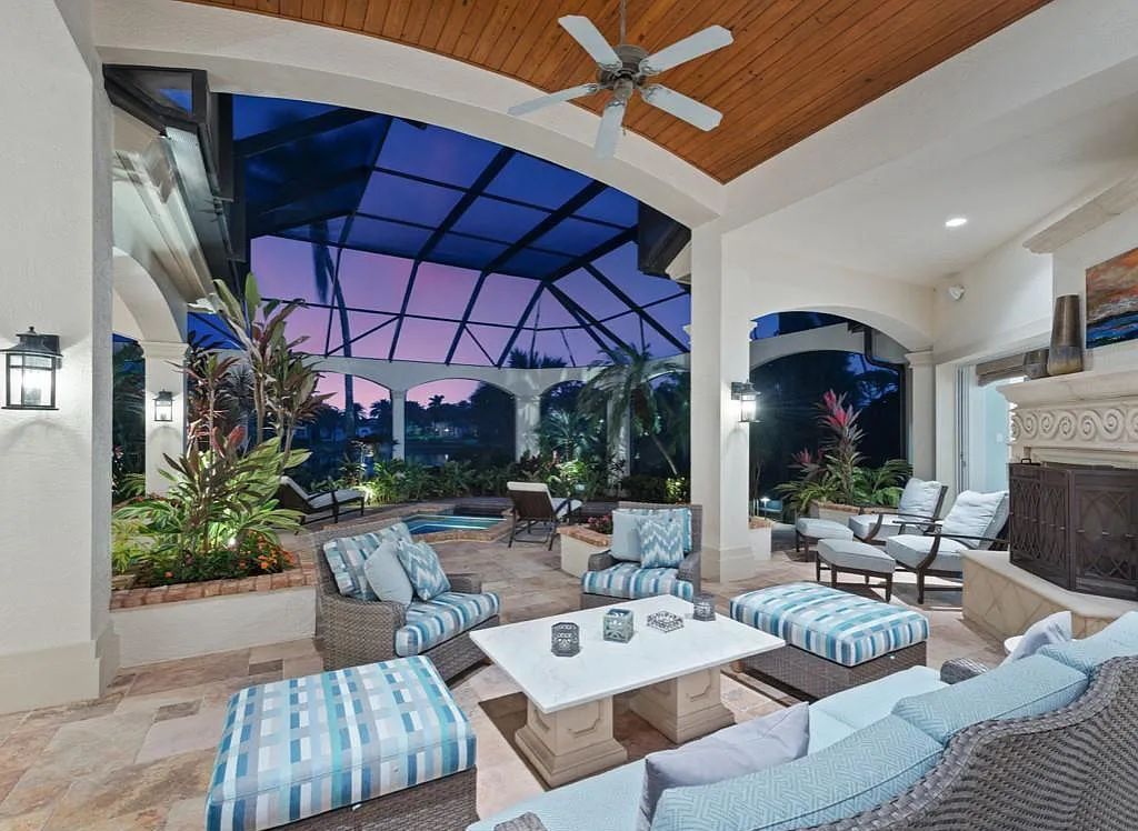 26079 Fawnwood Court, Bonita Springs, Florida, is a beautiful lakefront home built on a prominent corner lot in desirable Spring Ridge. With warm and inviting décor and a separate waterfall flowing into a tropical lagoon pool, it is a timeless design.