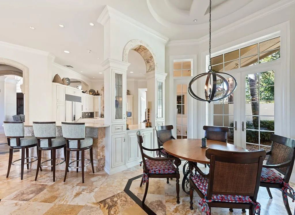26079 Fawnwood Court, Bonita Springs, Florida, is a beautiful lakefront home built on a prominent corner lot in desirable Spring Ridge. With warm and inviting décor and a separate waterfall flowing into a tropical lagoon pool, it is a timeless design.