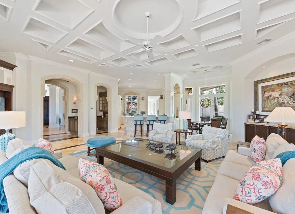 26079 Fawnwood Court, Bonita Springs, Florida, is a beautiful lakefront home built on a prominent corner lot in desirable Spring Ridge. With warm and inviting décor and a separate waterfall flowing into a tropical lagoon pool, it is a timeless design.