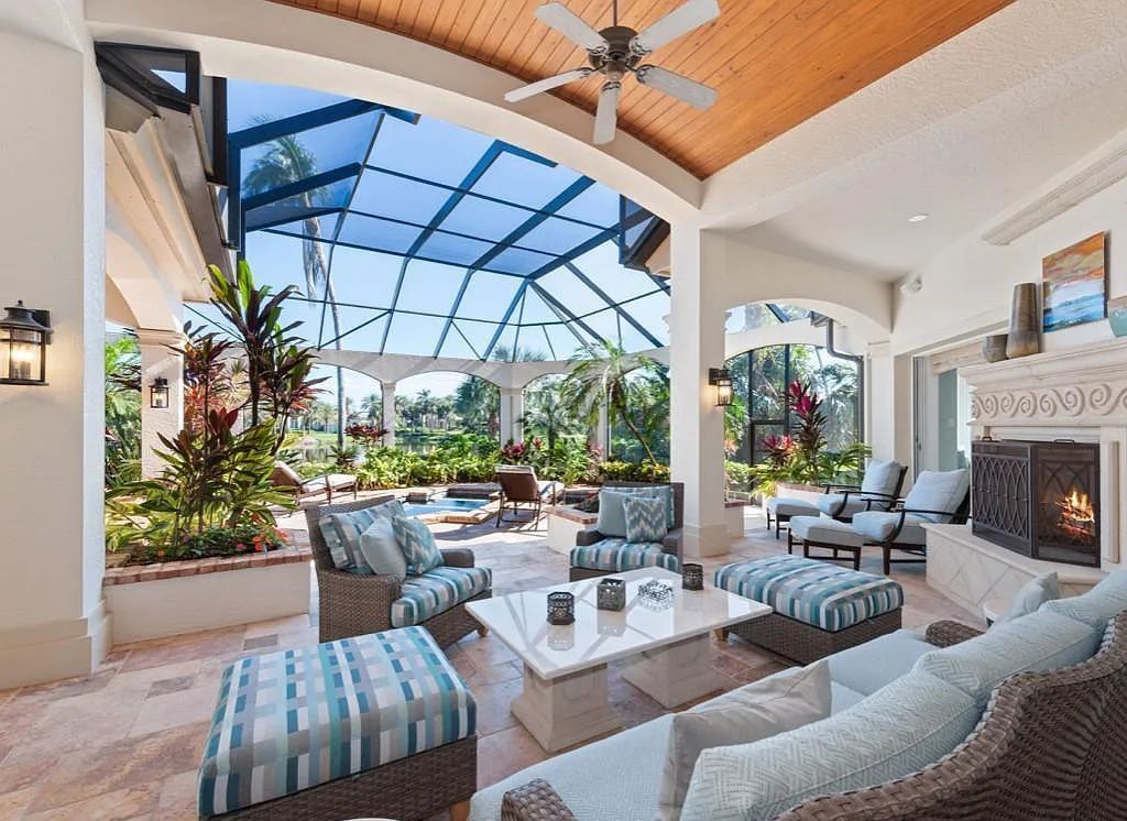 26079 Fawnwood Court, Bonita Springs, Florida, is a beautiful lakefront home built on a prominent corner lot in desirable Spring Ridge. With warm and inviting décor and a separate waterfall flowing into a tropical lagoon pool, it is a timeless design.