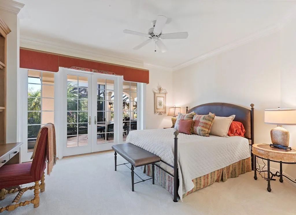 26079 Fawnwood Court, Bonita Springs, Florida, is a beautiful lakefront home built on a prominent corner lot in desirable Spring Ridge. With warm and inviting décor and a separate waterfall flowing into a tropical lagoon pool, it is a timeless design.