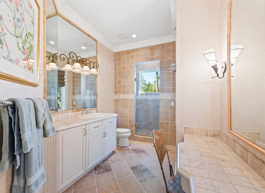 26079 Fawnwood Court, Bonita Springs, Florida, is a beautiful lakefront home built on a prominent corner lot in desirable Spring Ridge. With warm and inviting décor and a separate waterfall flowing into a tropical lagoon pool, it is a timeless design.