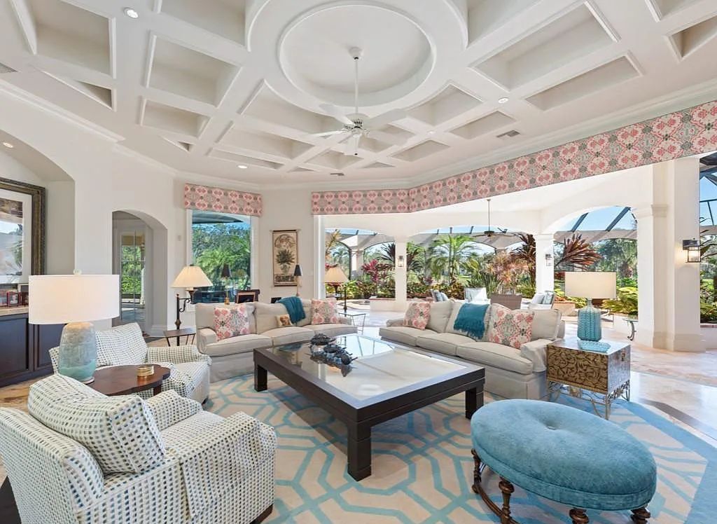 26079 Fawnwood Court, Bonita Springs, Florida, is a beautiful lakefront home built on a prominent corner lot in desirable Spring Ridge. With warm and inviting décor and a separate waterfall flowing into a tropical lagoon pool, it is a timeless design.