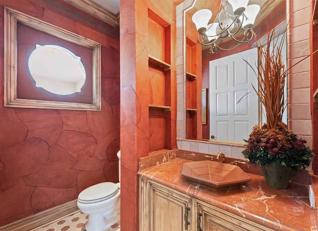 26079 Fawnwood Court, Bonita Springs, Florida, is a beautiful lakefront home built on a prominent corner lot in desirable Spring Ridge. With warm and inviting décor and a separate waterfall flowing into a tropical lagoon pool, it is a timeless design.