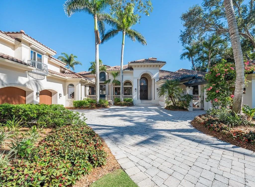 26079 Fawnwood Court, Bonita Springs, Florida, is a beautiful lakefront home built on a prominent corner lot in desirable Spring Ridge. With warm and inviting décor and a separate waterfall flowing into a tropical lagoon pool, it is a timeless design.