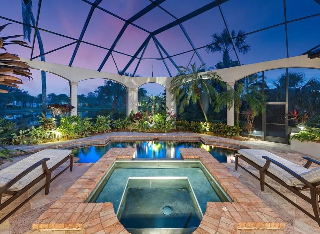 26079 Fawnwood Court, Bonita Springs, Florida, is a beautiful lakefront home built on a prominent corner lot in desirable Spring Ridge. With warm and inviting décor and a separate waterfall flowing into a tropical lagoon pool, it is a timeless design.