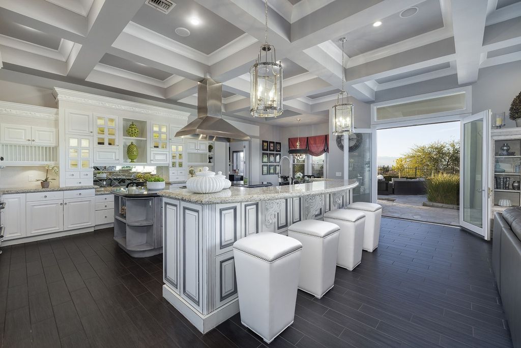 1513 Villa Rica Drive, Henderson, Nevada is a chic home in the Estates in Seven Hills with resort amenities including indoor-outdoor bar, movie theater, smart home, entertainers kitchen, bar seating, chic mirrored backsplash and more.