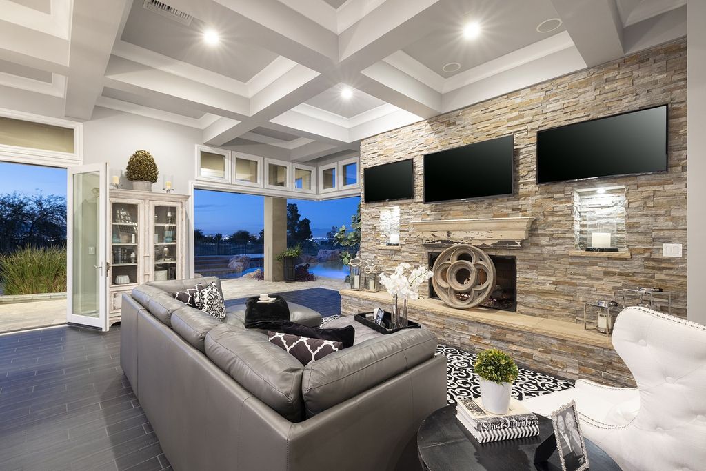 1513 Villa Rica Drive, Henderson, Nevada is a chic home in the Estates in Seven Hills with resort amenities including indoor-outdoor bar, movie theater, smart home, entertainers kitchen, bar seating, chic mirrored backsplash and more.