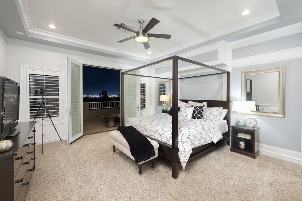 1513 Villa Rica Drive, Henderson, Nevada is a chic home in the Estates in Seven Hills with resort amenities including indoor-outdoor bar, movie theater, smart home, entertainers kitchen, bar seating, chic mirrored backsplash and more.