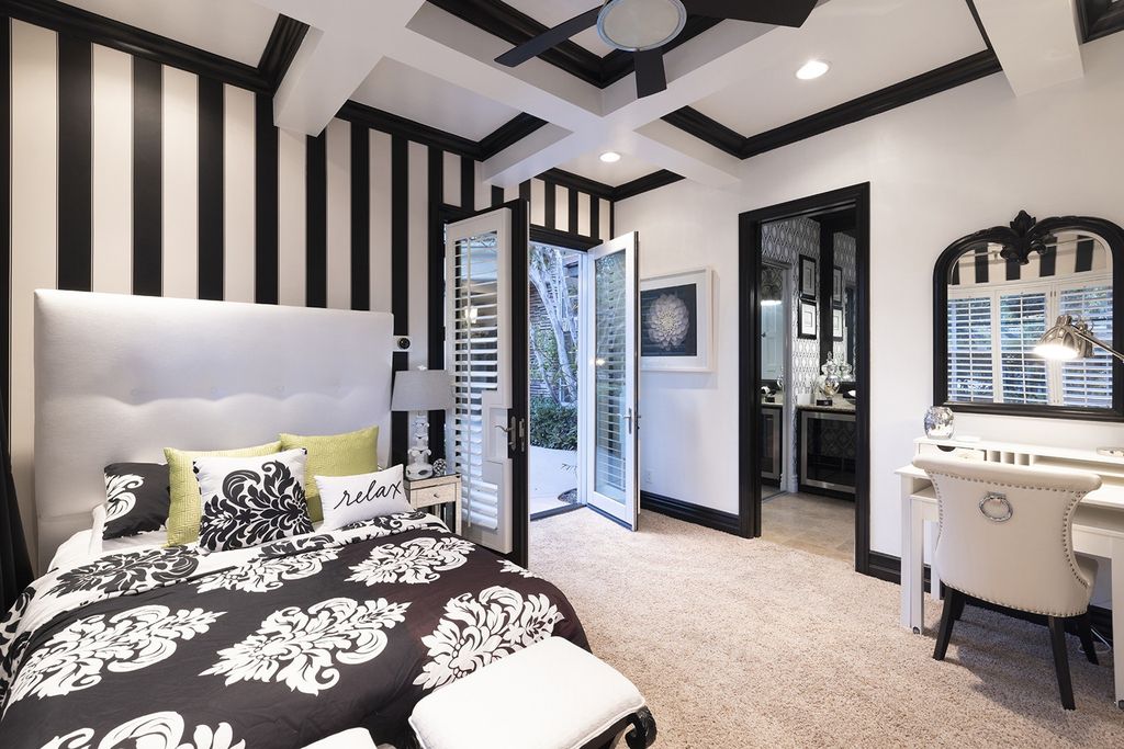 1513 Villa Rica Drive, Henderson, Nevada is a chic home in the Estates in Seven Hills with resort amenities including indoor-outdoor bar, movie theater, smart home, entertainers kitchen, bar seating, chic mirrored backsplash and more.