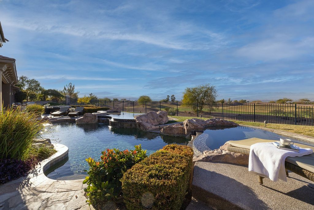 1513 Villa Rica Drive, Henderson, Nevada is a chic home in the Estates in Seven Hills with resort amenities including indoor-outdoor bar, movie theater, smart home, entertainers kitchen, bar seating, chic mirrored backsplash and more.