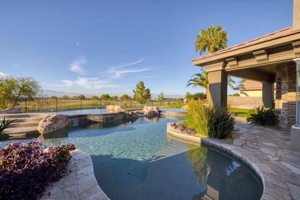 1513 Villa Rica Drive, Henderson, Nevada is a chic home in the Estates in Seven Hills with resort amenities including indoor-outdoor bar, movie theater, smart home, entertainers kitchen, bar seating, chic mirrored backsplash and more.