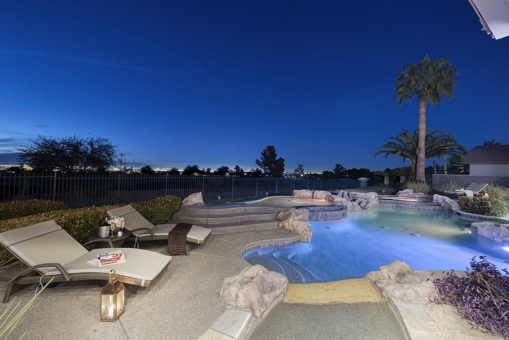 1513 Villa Rica Drive, Henderson, Nevada is a chic home in the Estates in Seven Hills with resort amenities including indoor-outdoor bar, movie theater, smart home, entertainers kitchen, bar seating, chic mirrored backsplash and more.