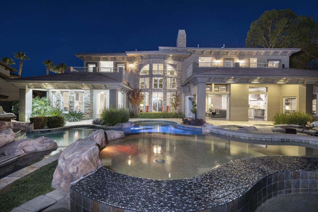 1513 Villa Rica Drive, Henderson, Nevada is a chic home in the Estates in Seven Hills with resort amenities including indoor-outdoor bar, movie theater, smart home, entertainers kitchen, bar seating, chic mirrored backsplash and more.