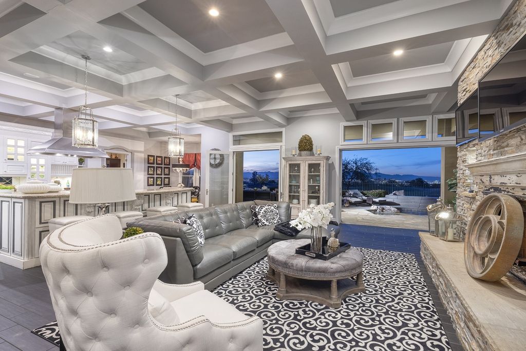 1513 Villa Rica Drive, Henderson, Nevada is a chic home in the Estates in Seven Hills with resort amenities including indoor-outdoor bar, movie theater, smart home, entertainers kitchen, bar seating, chic mirrored backsplash and more.
