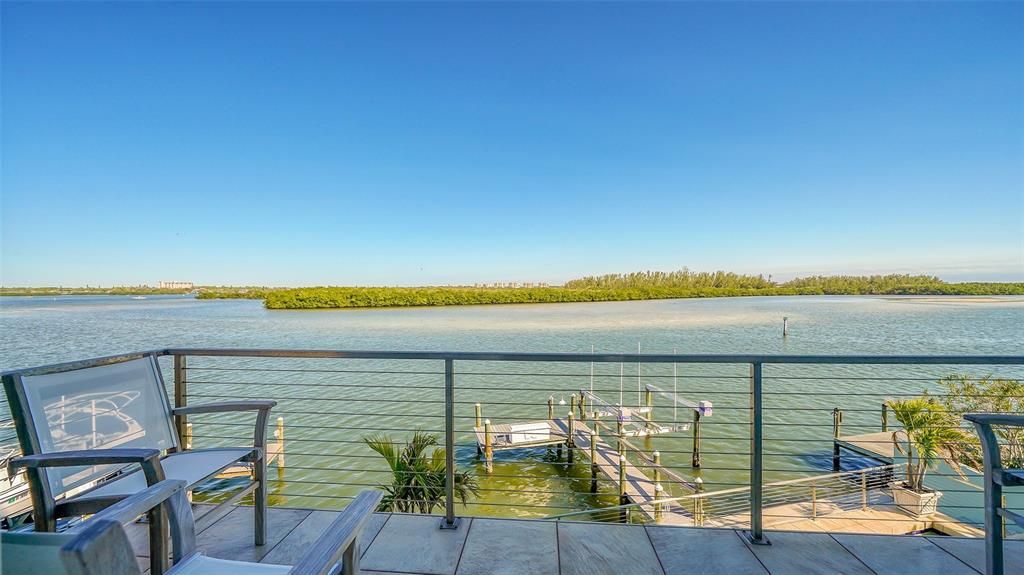 9137 Midnight Pass Road, Sarasota, Florida, is designed by the original owner and architect, Tony Ngai, and features expansive bay views from north to south on a quiet stretch.