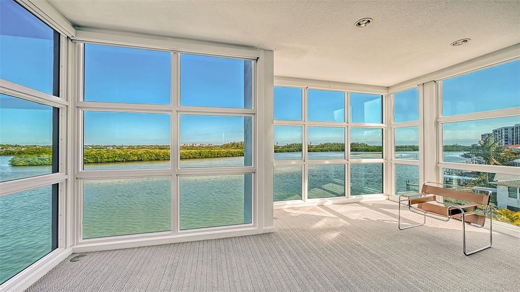 9137 Midnight Pass Road, Sarasota, Florida, is designed by the original owner and architect, Tony Ngai, and features expansive bay views from north to south on a quiet stretch.
