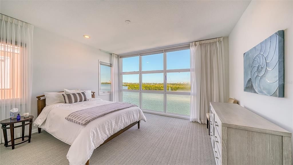 9137 Midnight Pass Road, Sarasota, Florida, is designed by the original owner and architect, Tony Ngai, and features expansive bay views from north to south on a quiet stretch.
