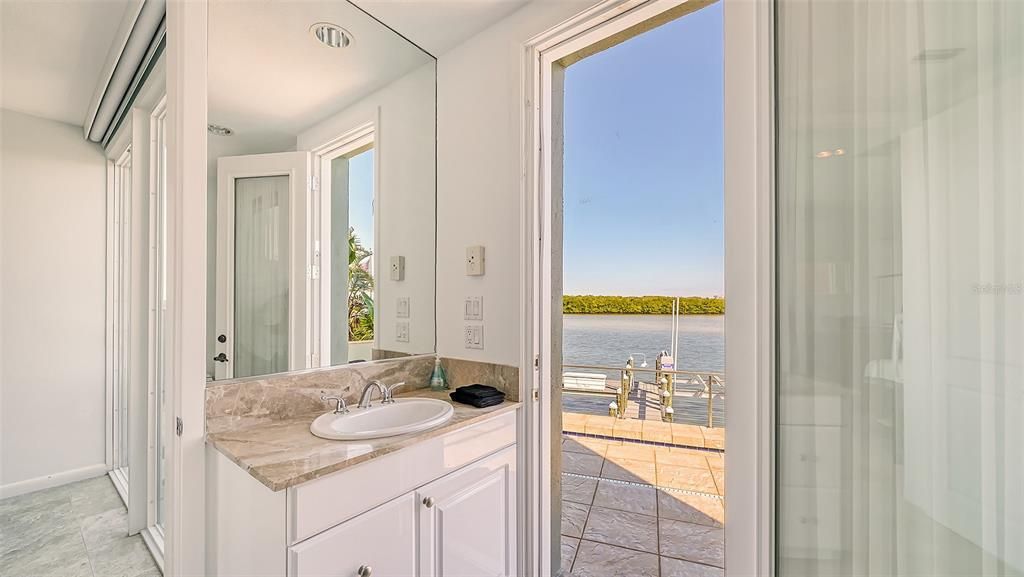 9137 Midnight Pass Road, Sarasota, Florida, is designed by the original owner and architect, Tony Ngai, and features expansive bay views from north to south on a quiet stretch.