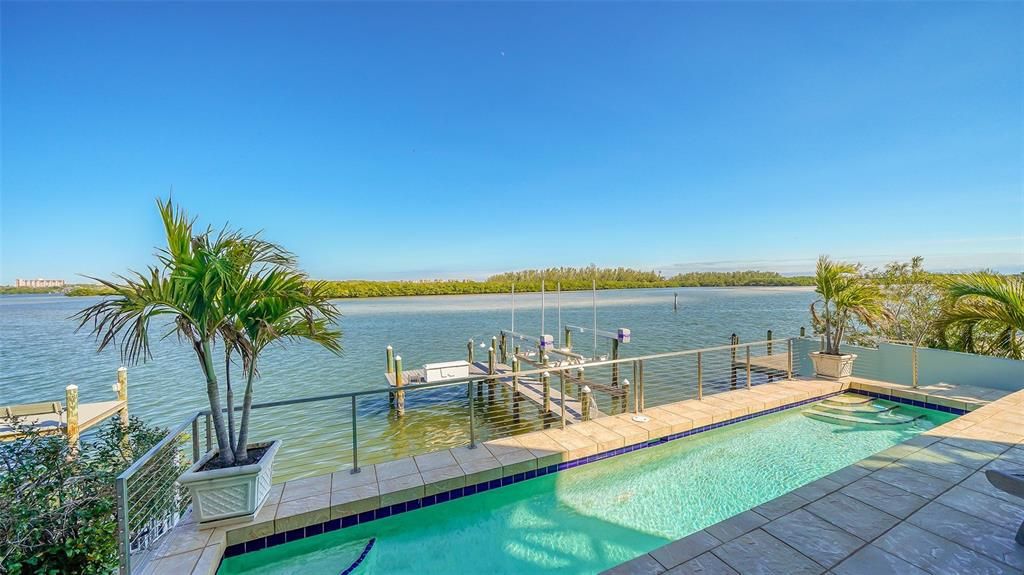 9137 Midnight Pass Road, Sarasota, Florida, is designed by the original owner and architect, Tony Ngai, and features expansive bay views from north to south on a quiet stretch.