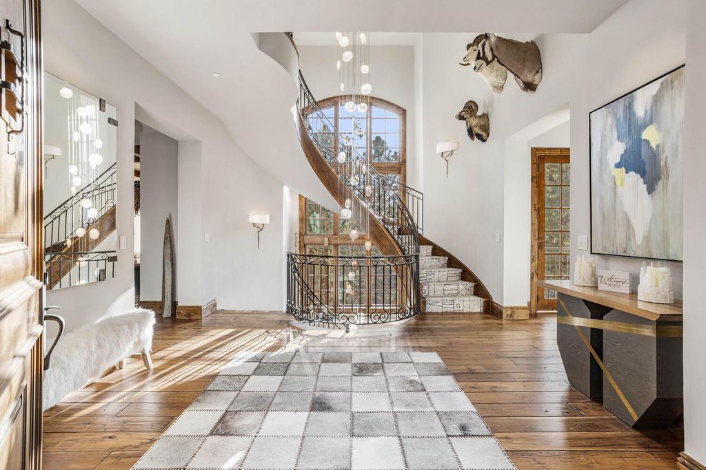 4 Eagle Pointe Lane, Castle Rock, Colorado is a a stunning renovation of a 2003 Trillium Home with the sweeping layout, along with dramatic wall and ceiling treatments, immaculate wood features, multiple fireplaces, and high-end designer finishes.