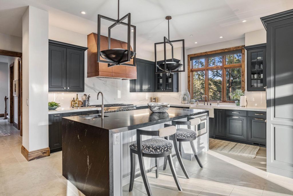 4 Eagle Pointe Lane, Castle Rock, Colorado is a a stunning renovation of a 2003 Trillium Home with the sweeping layout, along with dramatic wall and ceiling treatments, immaculate wood features, multiple fireplaces, and high-end designer finishes.