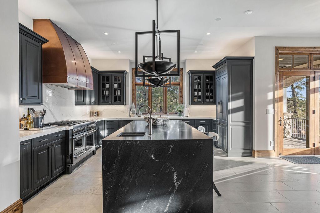 4 Eagle Pointe Lane, Castle Rock, Colorado is a a stunning renovation of a 2003 Trillium Home with the sweeping layout, along with dramatic wall and ceiling treatments, immaculate wood features, multiple fireplaces, and high-end designer finishes.