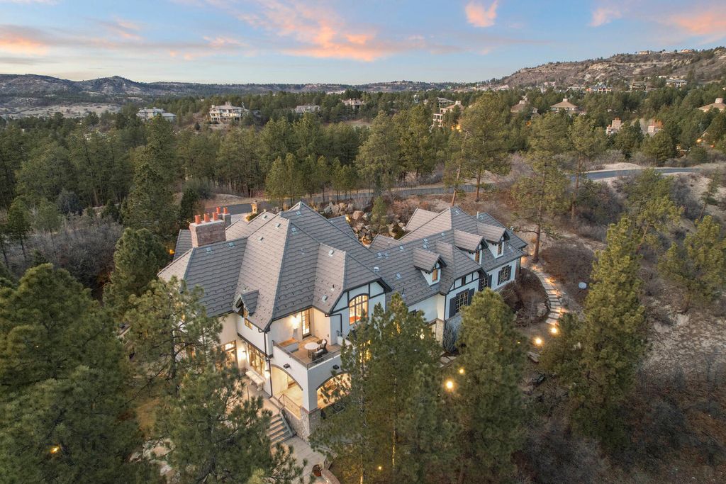 4 Eagle Pointe Lane, Castle Rock, Colorado is a a stunning renovation of a 2003 Trillium Home with the sweeping layout, along with dramatic wall and ceiling treatments, immaculate wood features, multiple fireplaces, and high-end designer finishes.