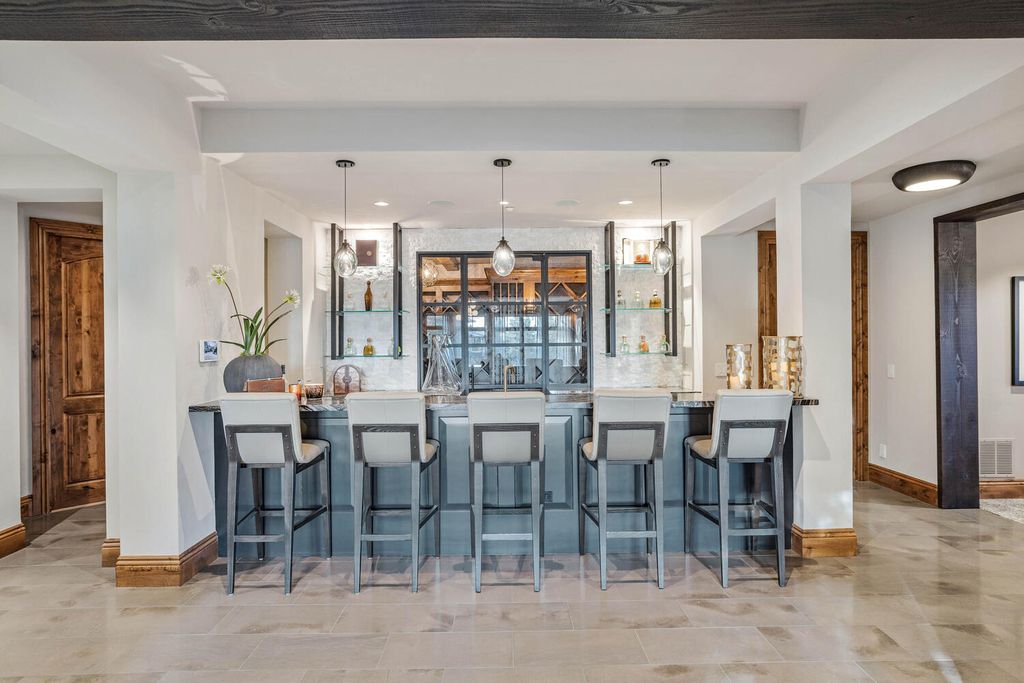 4 Eagle Pointe Lane, Castle Rock, Colorado is a a stunning renovation of a 2003 Trillium Home with the sweeping layout, along with dramatic wall and ceiling treatments, immaculate wood features, multiple fireplaces, and high-end designer finishes.
