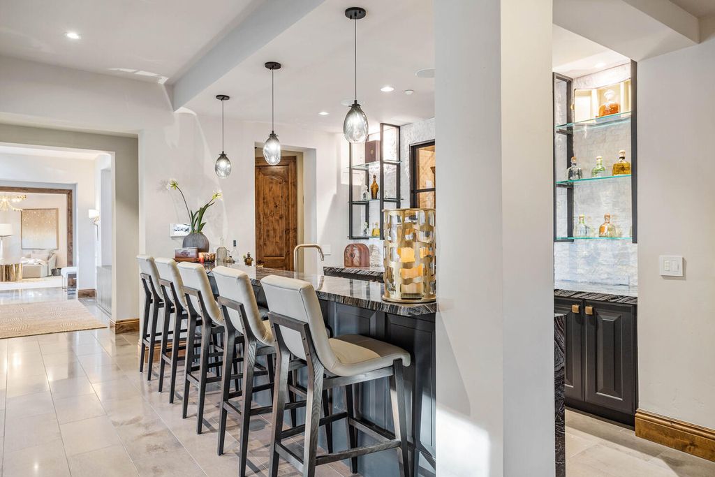 4 Eagle Pointe Lane, Castle Rock, Colorado is a a stunning renovation of a 2003 Trillium Home with the sweeping layout, along with dramatic wall and ceiling treatments, immaculate wood features, multiple fireplaces, and high-end designer finishes.