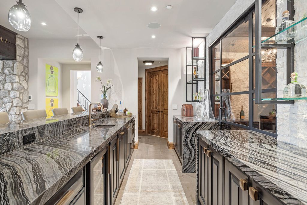 4 Eagle Pointe Lane, Castle Rock, Colorado is a a stunning renovation of a 2003 Trillium Home with the sweeping layout, along with dramatic wall and ceiling treatments, immaculate wood features, multiple fireplaces, and high-end designer finishes.