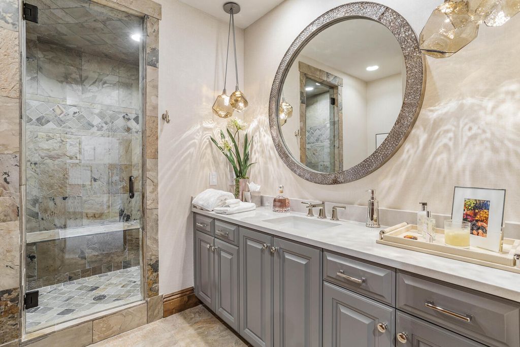 4 Eagle Pointe Lane, Castle Rock, Colorado is a a stunning renovation of a 2003 Trillium Home with the sweeping layout, along with dramatic wall and ceiling treatments, immaculate wood features, multiple fireplaces, and high-end designer finishes.