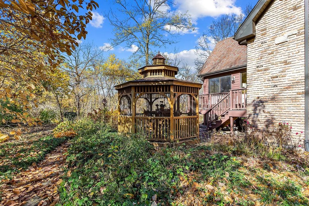 The Residence in Morris is surrounded by majestic, mature trees leading to your own private paradise, now available for sale. This home located at 4965 Cemetery Rd, Morris, Illinois