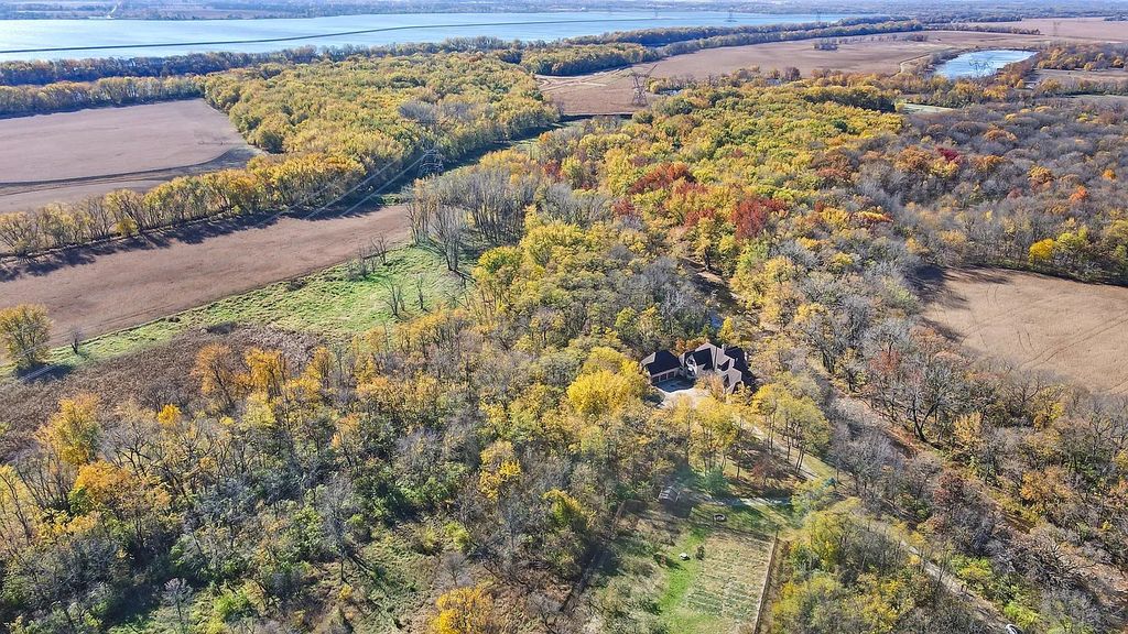 The Residence in Morris is surrounded by majestic, mature trees leading to your own private paradise, now available for sale. This home located at 4965 Cemetery Rd, Morris, Illinois