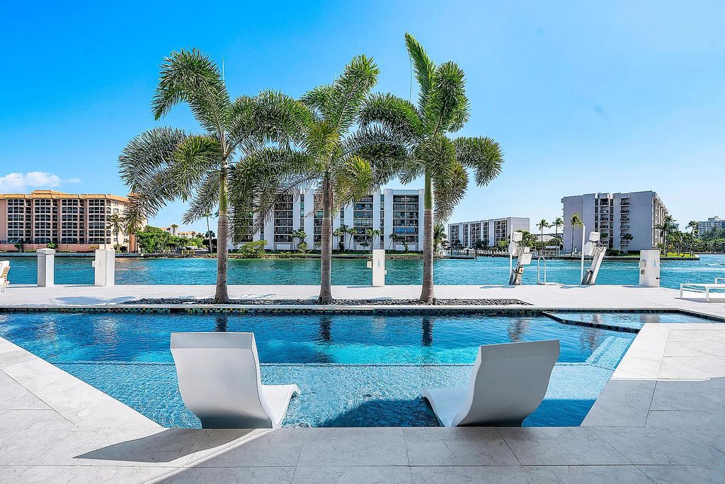 This exquisite 5 bedroom, 6 bathroom home is located on a prime waterfront lot in the highly sought-after area of Boca Raton, Florida. Built in 2003, 794 NE Harbour Drive boasts over 6,000 square feet of living space and sits on a spacious 0.22-acre lot. Upon entering the home, you'll be greeted by soaring ceilings and breathtaking water views that extend throughout the living areas, creating a bright and airy atmosphere.