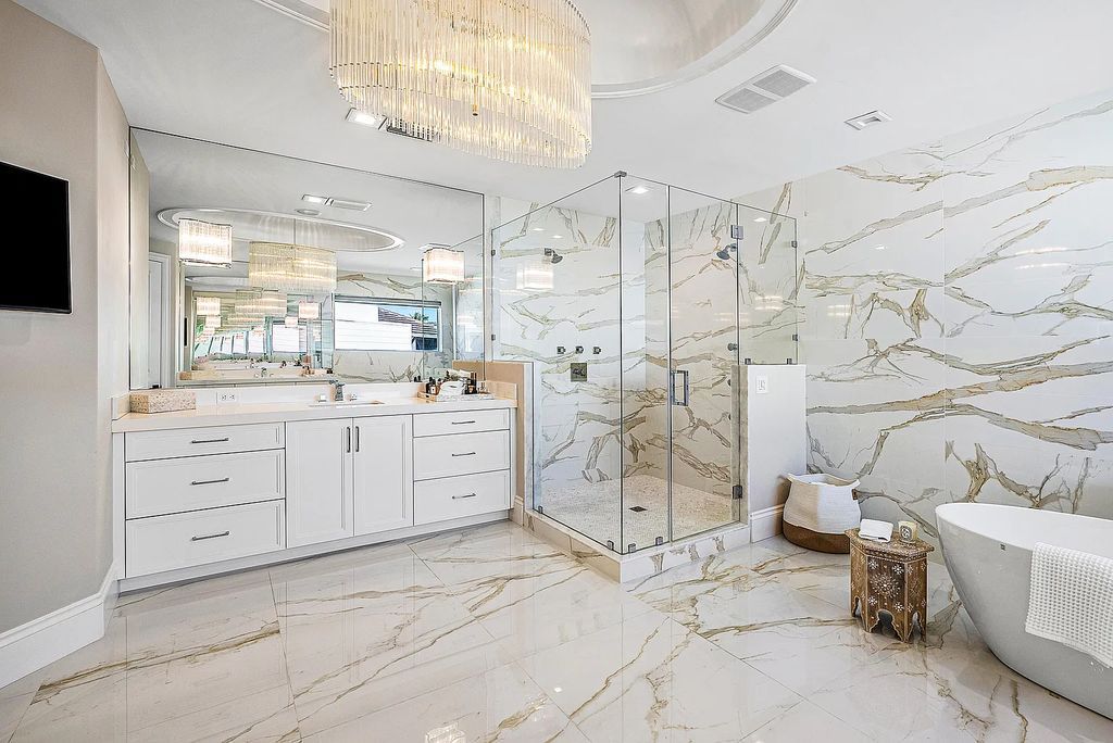 This exquisite 5 bedroom, 6 bathroom home is located on a prime waterfront lot in the highly sought-after area of Boca Raton, Florida. Built in 2003, 794 NE Harbour Drive boasts over 6,000 square feet of living space and sits on a spacious 0.22-acre lot. Upon entering the home, you'll be greeted by soaring ceilings and breathtaking water views that extend throughout the living areas, creating a bright and airy atmosphere.