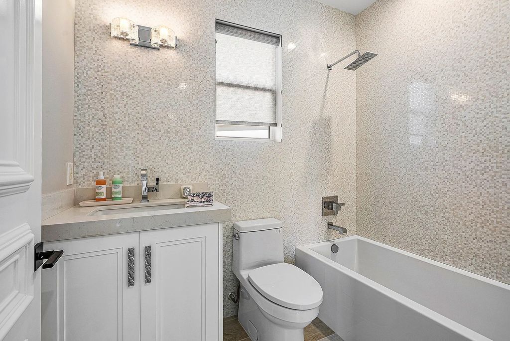 This exquisite 5 bedroom, 6 bathroom home is located on a prime waterfront lot in the highly sought-after area of Boca Raton, Florida. Built in 2003, 794 NE Harbour Drive boasts over 6,000 square feet of living space and sits on a spacious 0.22-acre lot. Upon entering the home, you'll be greeted by soaring ceilings and breathtaking water views that extend throughout the living areas, creating a bright and airy atmosphere.