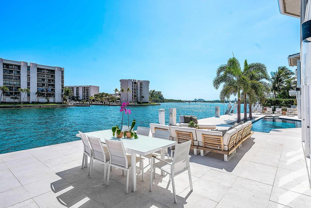 This exquisite 5 bedroom, 6 bathroom home is located on a prime waterfront lot in the highly sought-after area of Boca Raton, Florida. Built in 2003, 794 NE Harbour Drive boasts over 6,000 square feet of living space and sits on a spacious 0.22-acre lot. Upon entering the home, you'll be greeted by soaring ceilings and breathtaking water views that extend throughout the living areas, creating a bright and airy atmosphere.