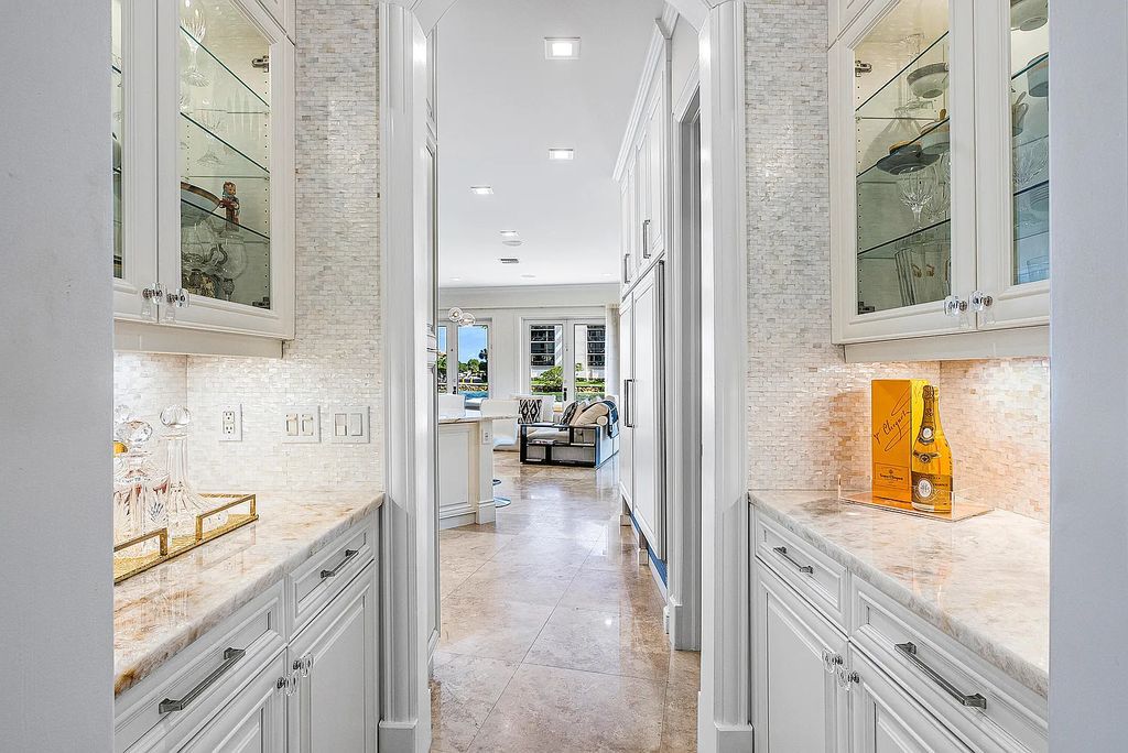 This exquisite 5 bedroom, 6 bathroom home is located on a prime waterfront lot in the highly sought-after area of Boca Raton, Florida. Built in 2003, 794 NE Harbour Drive boasts over 6,000 square feet of living space and sits on a spacious 0.22-acre lot. Upon entering the home, you'll be greeted by soaring ceilings and breathtaking water views that extend throughout the living areas, creating a bright and airy atmosphere.