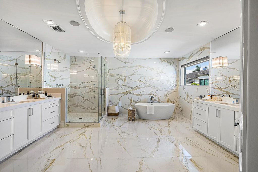 This exquisite 5 bedroom, 6 bathroom home is located on a prime waterfront lot in the highly sought-after area of Boca Raton, Florida. Built in 2003, 794 NE Harbour Drive boasts over 6,000 square feet of living space and sits on a spacious 0.22-acre lot. Upon entering the home, you'll be greeted by soaring ceilings and breathtaking water views that extend throughout the living areas, creating a bright and airy atmosphere.