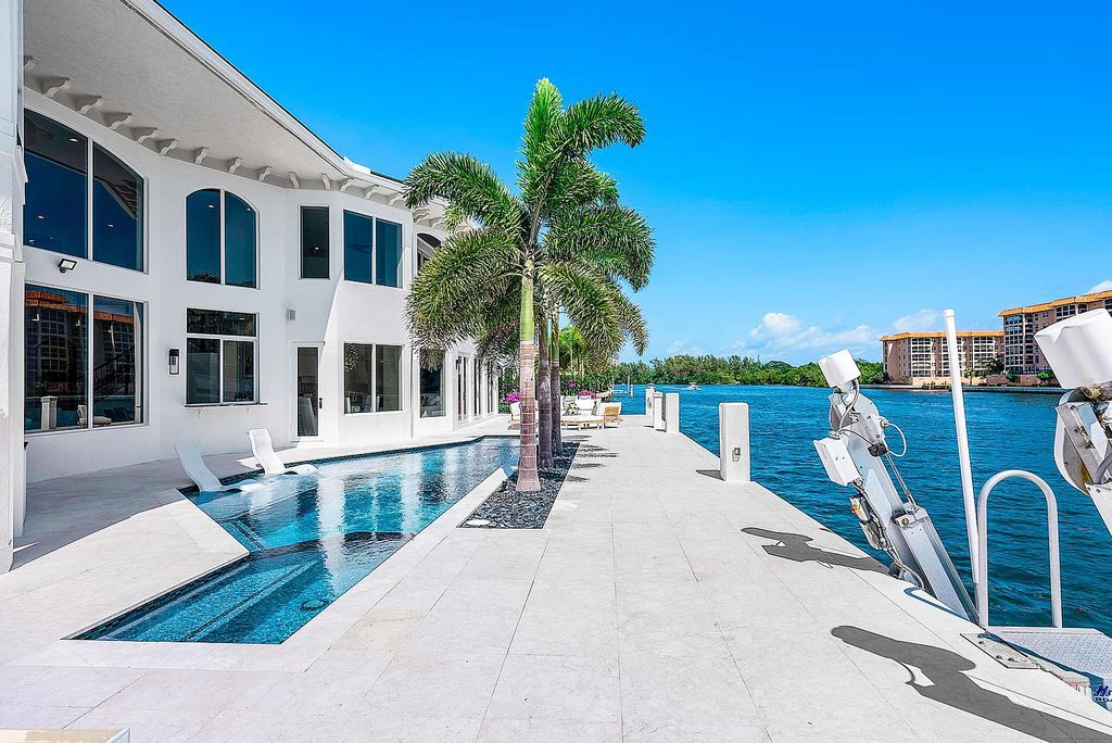 This exquisite 5 bedroom, 6 bathroom home is located on a prime waterfront lot in the highly sought-after area of Boca Raton, Florida. Built in 2003, 794 NE Harbour Drive boasts over 6,000 square feet of living space and sits on a spacious 0.22-acre lot. Upon entering the home, you'll be greeted by soaring ceilings and breathtaking water views that extend throughout the living areas, creating a bright and airy atmosphere.
