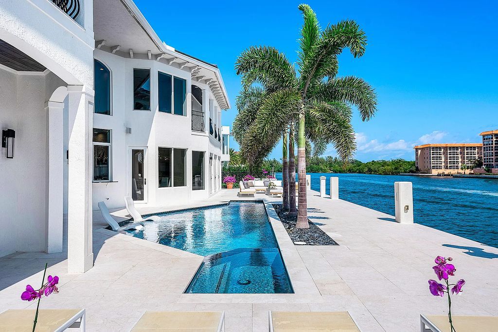 This exquisite 5 bedroom, 6 bathroom home is located on a prime waterfront lot in the highly sought-after area of Boca Raton, Florida. Built in 2003, 794 NE Harbour Drive boasts over 6,000 square feet of living space and sits on a spacious 0.22-acre lot. Upon entering the home, you'll be greeted by soaring ceilings and breathtaking water views that extend throughout the living areas, creating a bright and airy atmosphere.