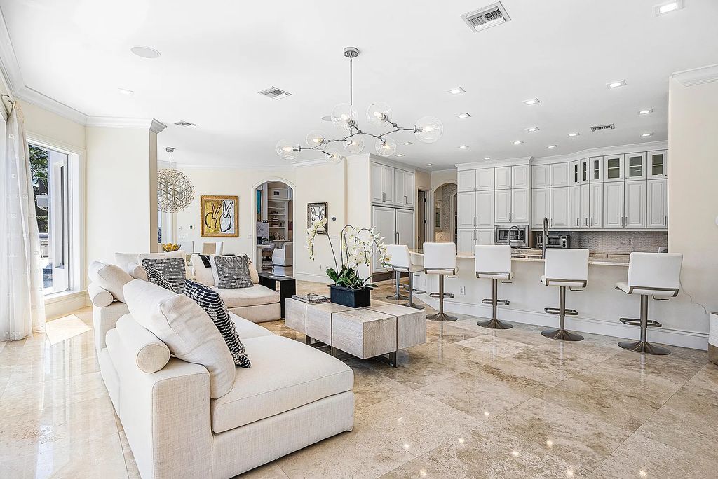 This exquisite 5 bedroom, 6 bathroom home is located on a prime waterfront lot in the highly sought-after area of Boca Raton, Florida. Built in 2003, 794 NE Harbour Drive boasts over 6,000 square feet of living space and sits on a spacious 0.22-acre lot. Upon entering the home, you'll be greeted by soaring ceilings and breathtaking water views that extend throughout the living areas, creating a bright and airy atmosphere.