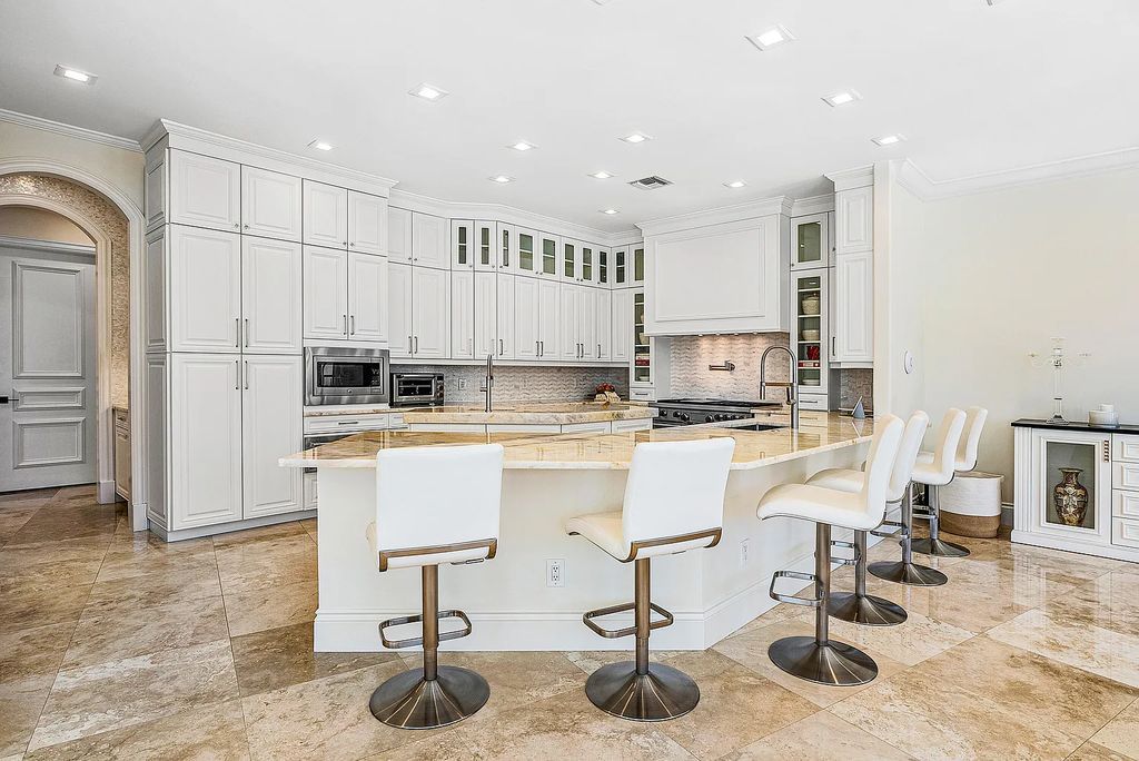 This exquisite 5 bedroom, 6 bathroom home is located on a prime waterfront lot in the highly sought-after area of Boca Raton, Florida. Built in 2003, 794 NE Harbour Drive boasts over 6,000 square feet of living space and sits on a spacious 0.22-acre lot. Upon entering the home, you'll be greeted by soaring ceilings and breathtaking water views that extend throughout the living areas, creating a bright and airy atmosphere.
