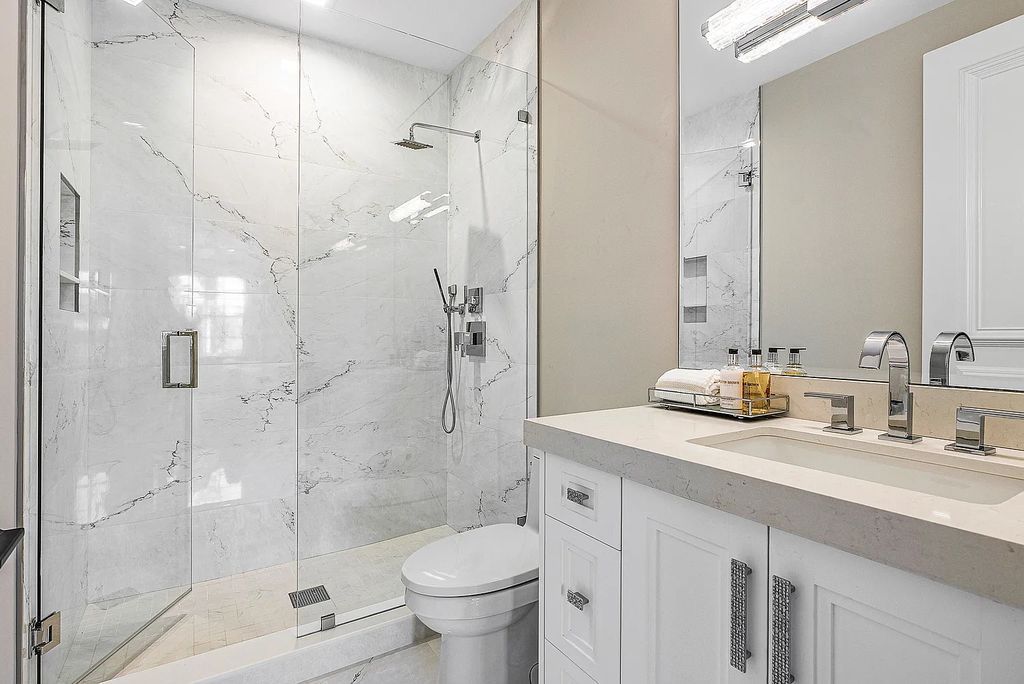 This exquisite 5 bedroom, 6 bathroom home is located on a prime waterfront lot in the highly sought-after area of Boca Raton, Florida. Built in 2003, 794 NE Harbour Drive boasts over 6,000 square feet of living space and sits on a spacious 0.22-acre lot. Upon entering the home, you'll be greeted by soaring ceilings and breathtaking water views that extend throughout the living areas, creating a bright and airy atmosphere.